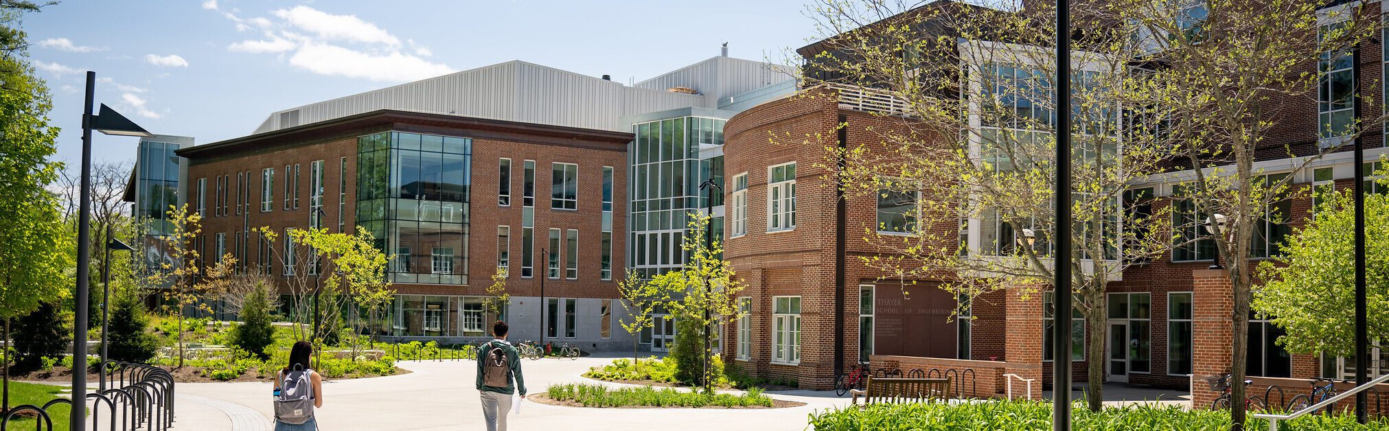 Two students walk toward the Class of 1982 Engineering and Computer Science Center on a sunny day.
